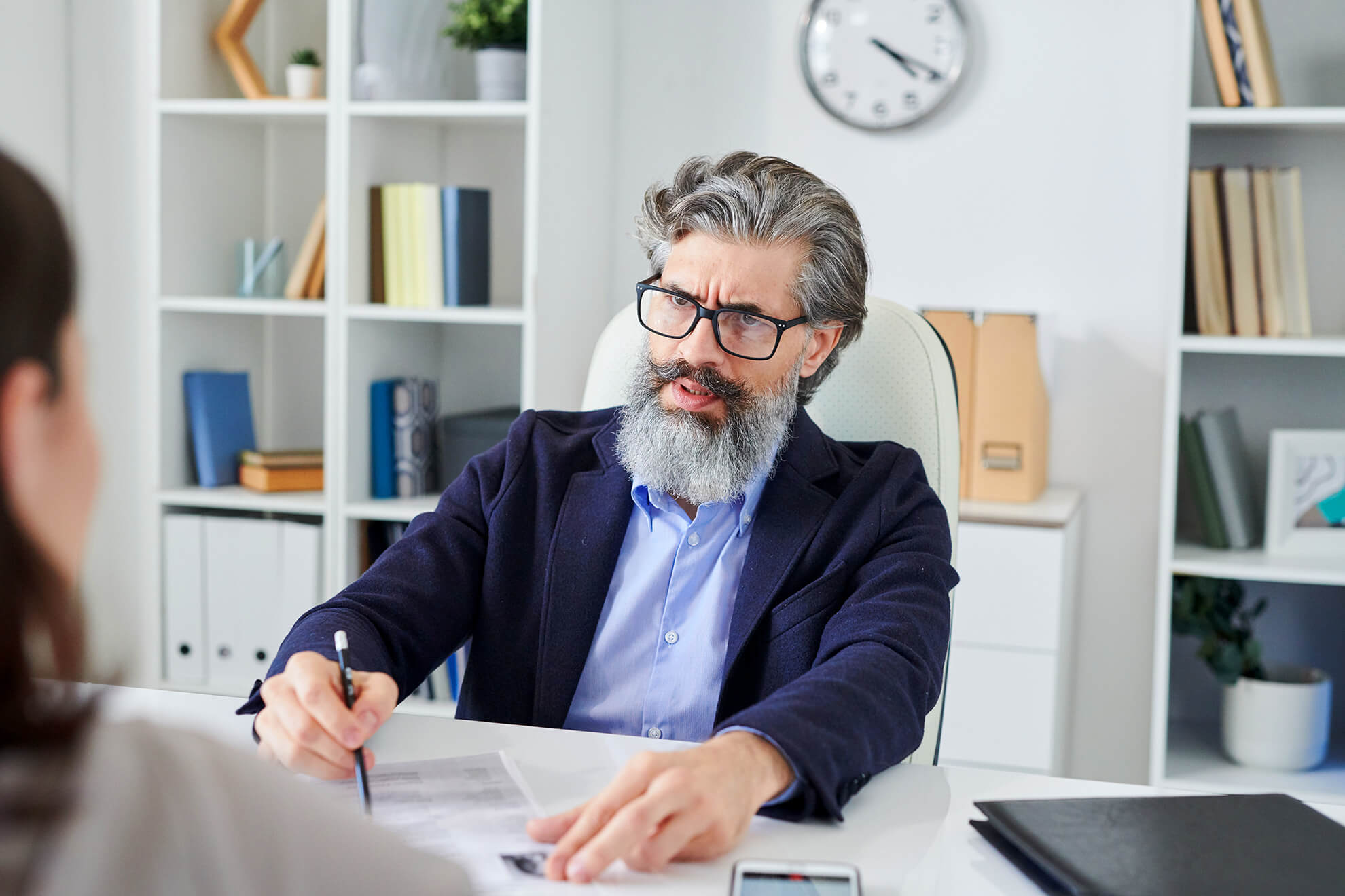 Serious hr manager in a employee workplace discipline meeting